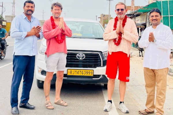 Group of travelers standing beside a vehicle