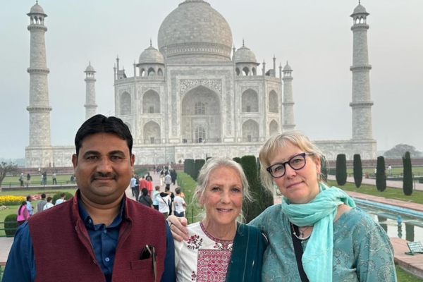 Tourists taking a photo in front of the Taj Mahal