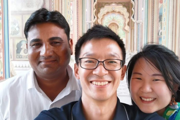 Smiling international tourists with private driver during Rajasthan trip