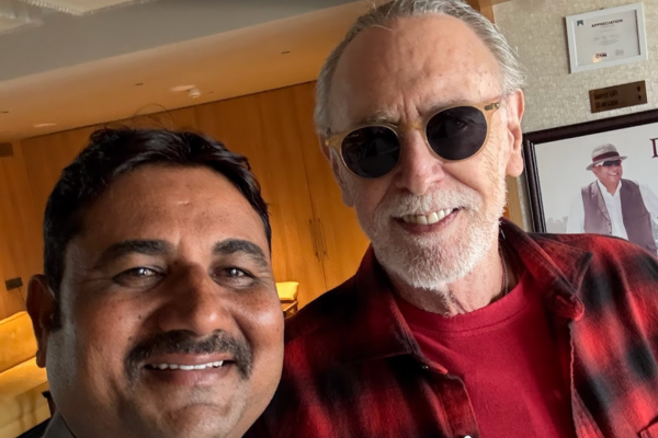 Tour guide taking selfie with international guest at hotel