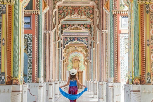 Tourist exploring colorful palace corridor in Rajasthan