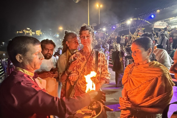 Travelers participating in traditional spiritual ceremony with monks