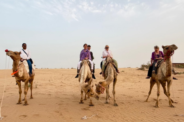 Tourists enjoying a camel ride in Jaisalmer desert
