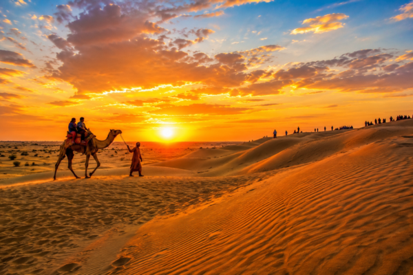 Camel safari at Sam Sand Dunes during sunset