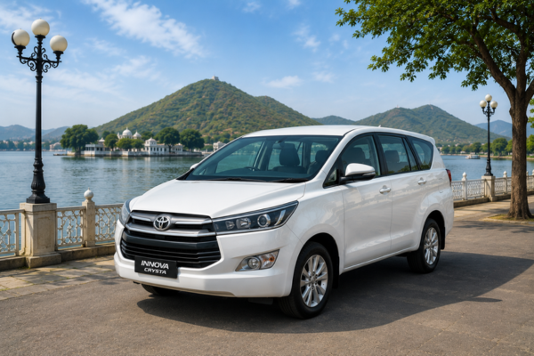 White Innova parked beside a scenic lakeside road