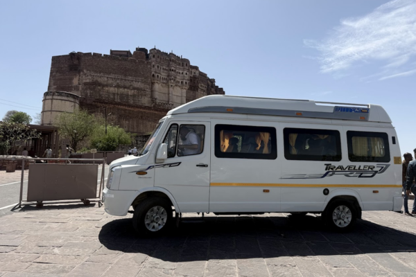 White tempo traveller parked near Mehrangarh Fort in Jodhpur.