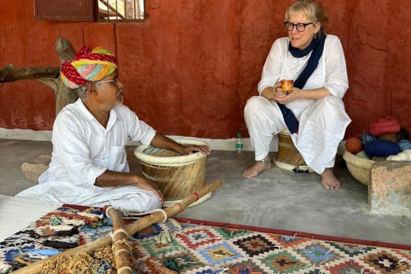 Tourists visiting a Bishnoi village while a local artisan demonstrates traditional rope-making techniques