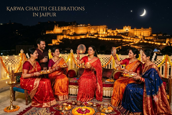 Group of women celebrating Karwa Chauth on a rooftop with Amer Fort in the background in Jaipur.