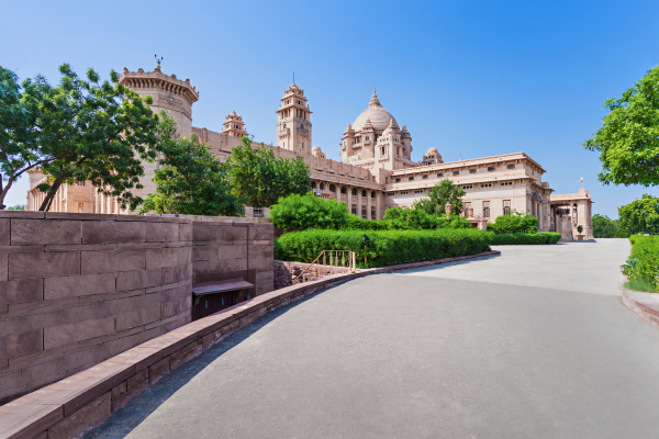 Tourists visiting the grand Umaid Bhawan Palace surrounded by beautiful gardens in Jodhpur