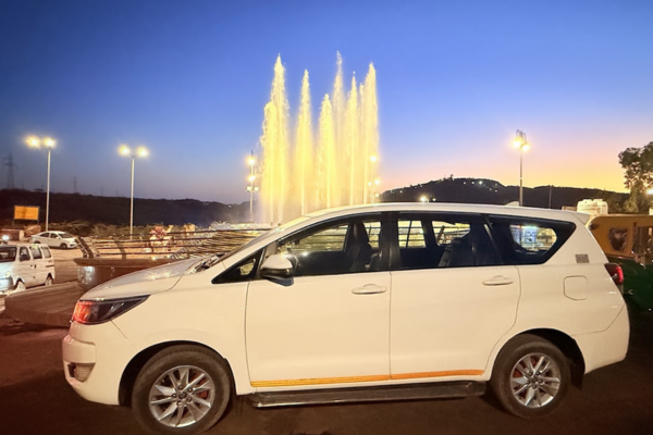 White Toyota Innova Crysta parked near the peaceful Kailana Lake in Jodhpur, Rajasthan