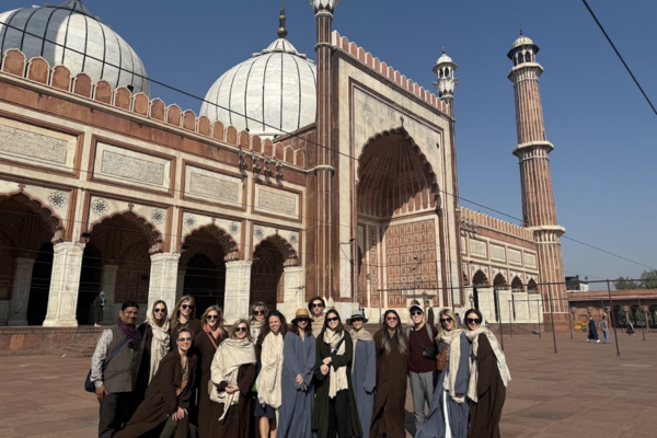 Group of tourists taking photos during a guided tour of Agra Fort, India